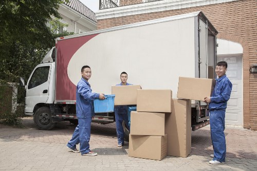Man and van worker lifting boxes safely
