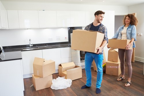 Professional movers loading items into a removal van on a central London street