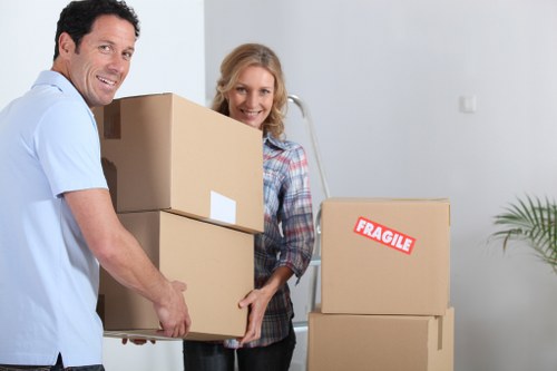 Moving crew transporting furniture through a central London property entrance